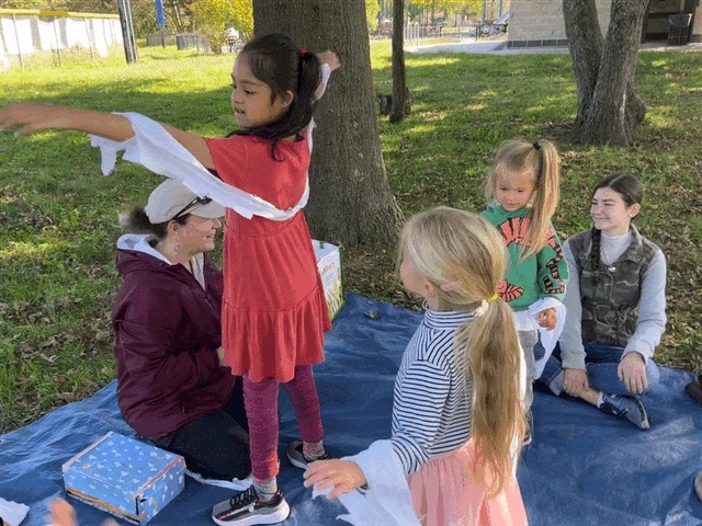 Children and guides outdoors during a group activity at Elements Workspace.